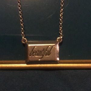 Silver “beautiful” logo